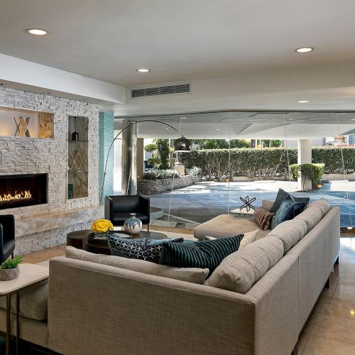 A bright, modern office or classroom with desks, chairs, a whiteboard, shelves, and a window, neatly organized and well-lit.