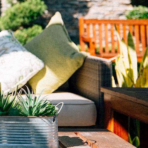 A cozy kitchen scene with fresh vegetables, herbs, and bowls arranged on a wooden counter, suggesting a meal prep or market vibe.