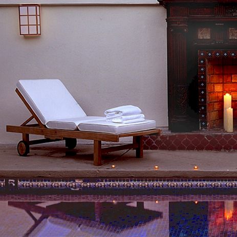 A stylish living room with a modern fireplace, leather sofas, and a low coffee table in the center, plus a cozy, upscale vibe.