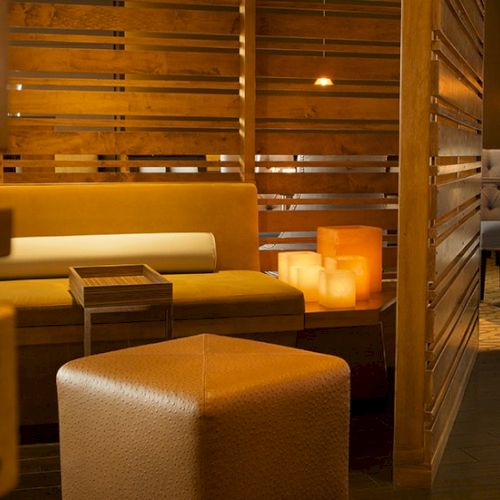 A cozy, modern restaurant or lounge with warm lighting, wooden furniture, and soft seating&mdash;invite you to relax and dine.