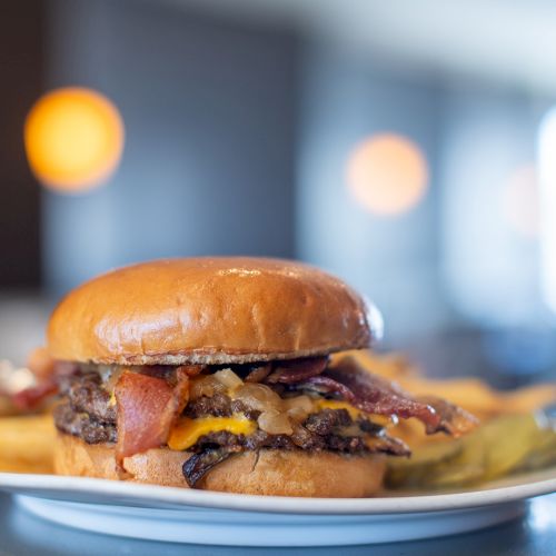 A stack of pancakes with syrup on a plate, whisking breakfast vibes on a bright kitchen counter.